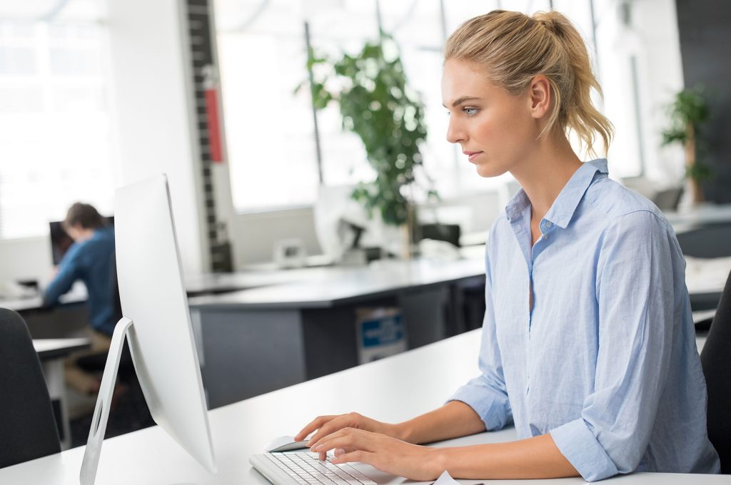 woman at desk entering data to vendor master file